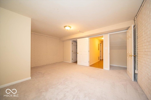 8410 Hague Rd Unit 5, Indianapolis, IN 46256 - unfurnished bedroom featuring brick wall, carpet floors, and a closet