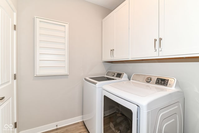 8263 Bryce Blvd, Pendleton, IN 46064 - laundry area featuring washing machine and clothes dryer, cabinet space, wood finished floors, and baseboards