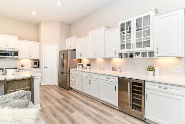 8263 Bryce Blvd, Pendleton, IN 46064 - kitchen featuring beverage cooler, stainless steel appliances, light countertops, white cabinets, and recessed lighting