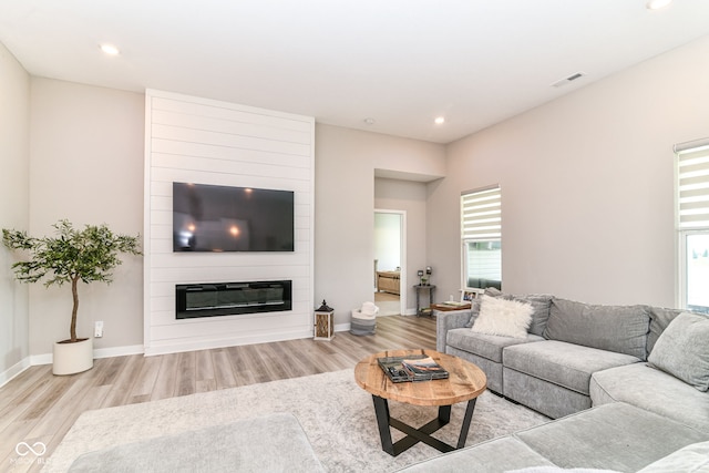 8263 Bryce Blvd, Pendleton, IN 46064 - living area featuring wood finished floors, healthy amount of natural light, a fireplace, baseboards, and recessed lighting