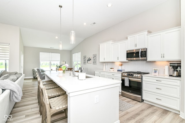 8263 Bryce Blvd, Pendleton, IN 46064 - kitchen with appliances with stainless steel finishes, open floor plan, a sink, light countertops, and healthy amount of natural light