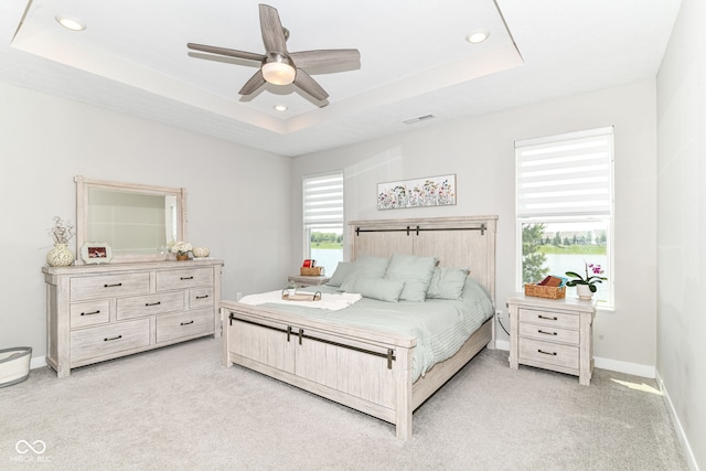 8263 Bryce Blvd, Pendleton, IN 46064 - bedroom with light carpet, a tray ceiling, baseboards, recessed lighting, and a ceiling fan