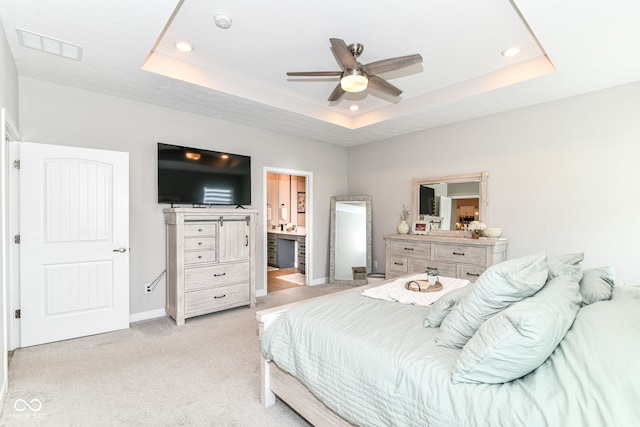 8263 Bryce Blvd, Pendleton, IN 46064 - bedroom featuring a tray ceiling, light colored carpet, recessed lighting, connected bathroom, and baseboards