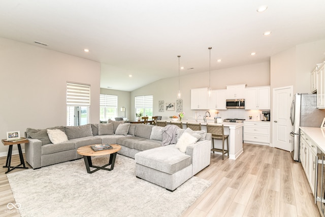 8263 Bryce Blvd, Pendleton, IN 46064 - living room featuring light wood finished floors, vaulted ceiling, and recessed lighting