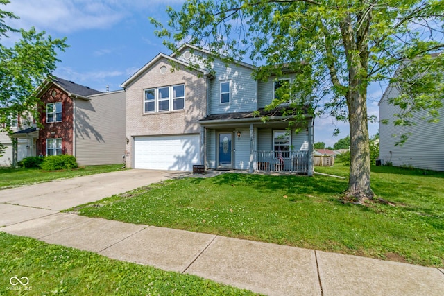 3362 Pavetto Ln, Indianapolis, IN 46203 - traditional-style house with covered porch, driveway, an attached garage, and a front lawn