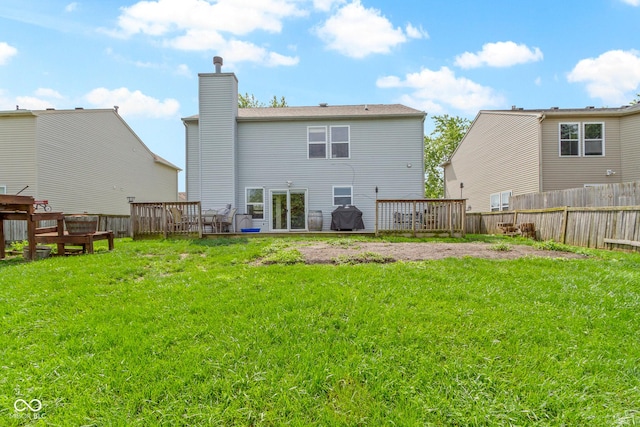 3362 Pavetto Ln, Indianapolis, IN 46203 - rear view of house with a chimney, a fenced backyard, and a deck