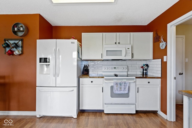 3362 Pavetto Ln, Indianapolis, IN 46203 - kitchen featuring white appliances, white cabinetry, tasteful backsplash, wood finished floors, and a textured ceiling