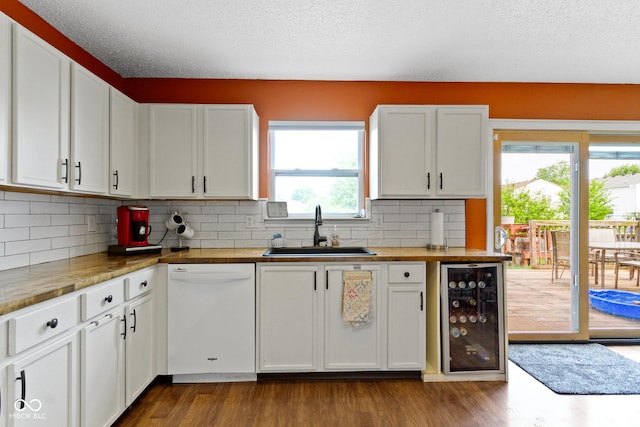 3362 Pavetto Ln, Indianapolis, IN 46203 - kitchen with white dishwasher, beverage cooler, decorative backsplash, white cabinets, and dark wood-style floors