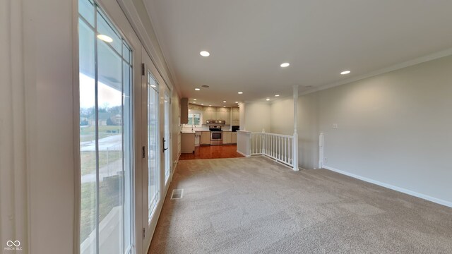 5939 Brendonridge Ct S, Indianapolis, IN 46226 - unfurnished living room featuring recessed lighting, light colored carpet, crown molding, and baseboards