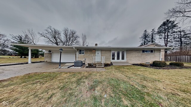 5939 Brendonridge Ct S, Indianapolis, IN 46226 - rear view of house featuring entry steps, an attached garage, driveway, stone siding, and central air condition unit