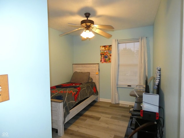 6714 Colleens Way, Indianapolis, IN 46221 - bedroom with wood finished floors, ceiling fan, and baseboards