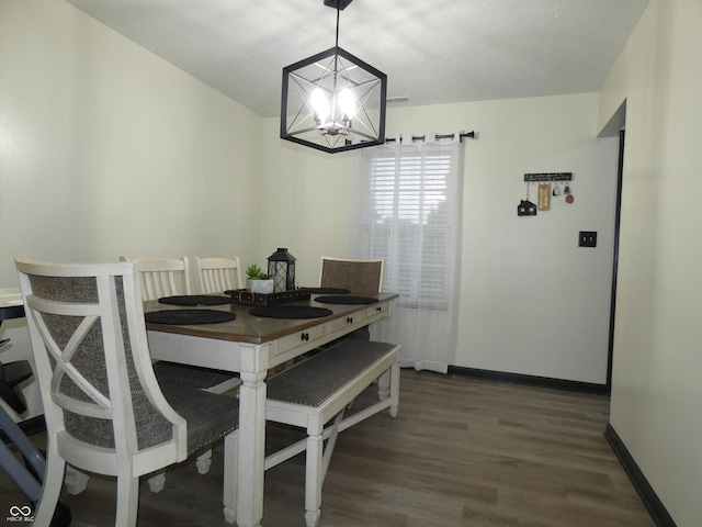 6714 Colleens Way, Indianapolis, IN 46221 - dining area with a chandelier, wood finished floors, and baseboards