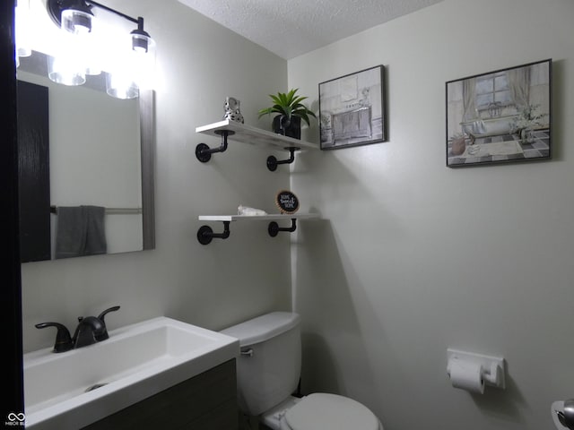 6714 Colleens Way, Indianapolis, IN 46221 - half bathroom featuring toilet, a textured ceiling, and vanity