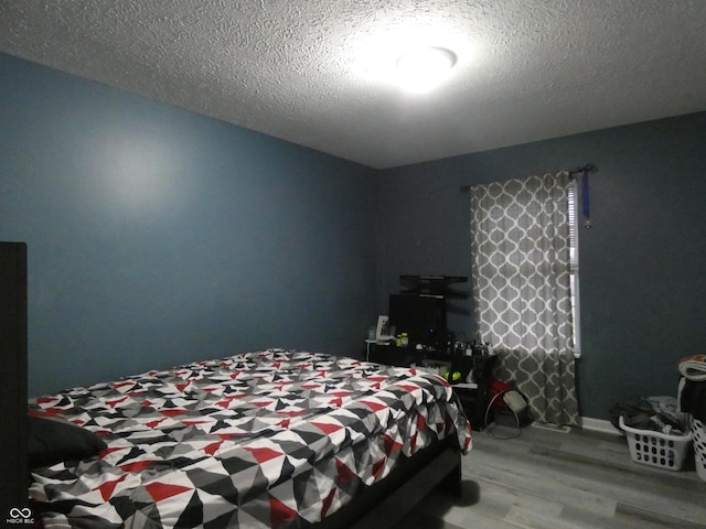 6714 Colleens Way, Indianapolis, IN 46221 - bedroom with wood finished floors and a textured ceiling