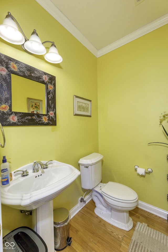 2553 Forest Hills Blvd, Greenwood, IN 46143 - half bath featuring toilet, wood finished floors, baseboards, and crown molding