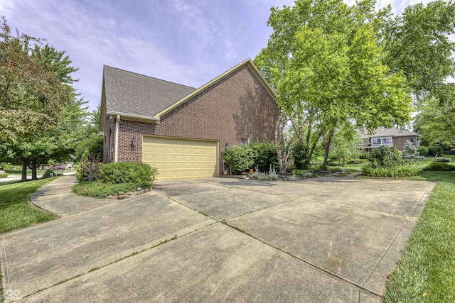 2553 Forest Hills Blvd, Greenwood, IN 46143 - view of home's exterior featuring brick siding, driveway, a garage, and a shingled roof