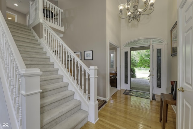2553 Forest Hills Blvd, Greenwood, IN 46143 - entrance foyer with light wood-style floors, a chandelier, stairway, a high ceiling, and baseboards
