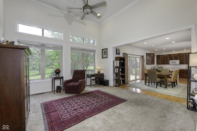 2553 Forest Hills Blvd, Greenwood, IN 46143 - living area with ornamental molding, ceiling fan, recessed lighting, a towering ceiling, and light wood-style floors