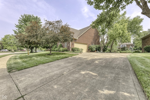 2553 Forest Hills Blvd, Greenwood, IN 46143 - view of property hidden behind natural elements featuring brick siding, concrete driveway, a front lawn, and an attached garage