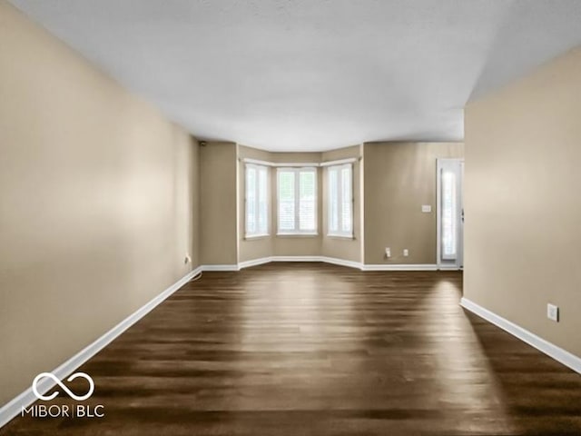 7211 Topp Creek Ct, Indianapolis, IN 46214 - empty room with dark wood finished floors and baseboards