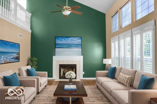 7211 Topp Creek Ct, Indianapolis, IN 46214 - living room with high vaulted ceiling, ceiling fan, wood finished floors, and a tile fireplace