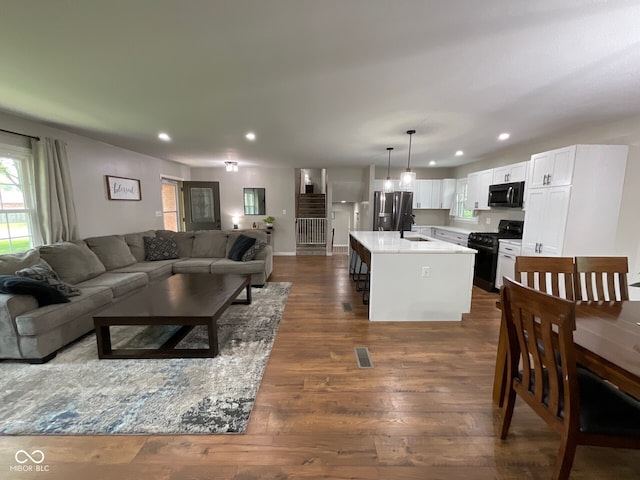 3520 Lantern Ln, Columbus, IN 47203 - living room with dark wood-style floors, recessed lighting, and baseboards