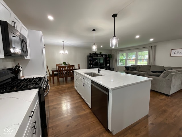 3520 Lantern Ln, Columbus, IN 47203 - kitchen with stainless steel microwave, black gas stove, dishwashing machine, a sink, and a chandelier