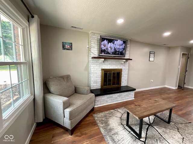 3520 Lantern Ln, Columbus, IN 47203 - living area with wood finished floors, baseboards, a brick fireplace, and recessed lighting