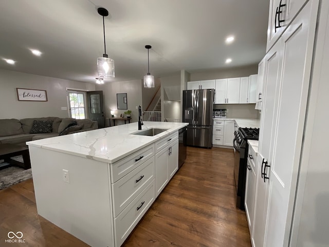 3520 Lantern Ln, Columbus, IN 47203 - kitchen featuring a sink, refrigerator with ice dispenser, gas stove, open floor plan, and an island with sink