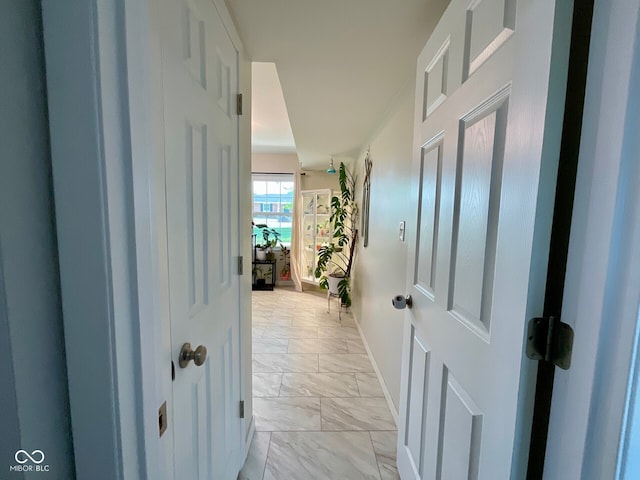 3520 Lantern Ln, Columbus, IN 47203 - hallway featuring light marble finish flooring and baseboards