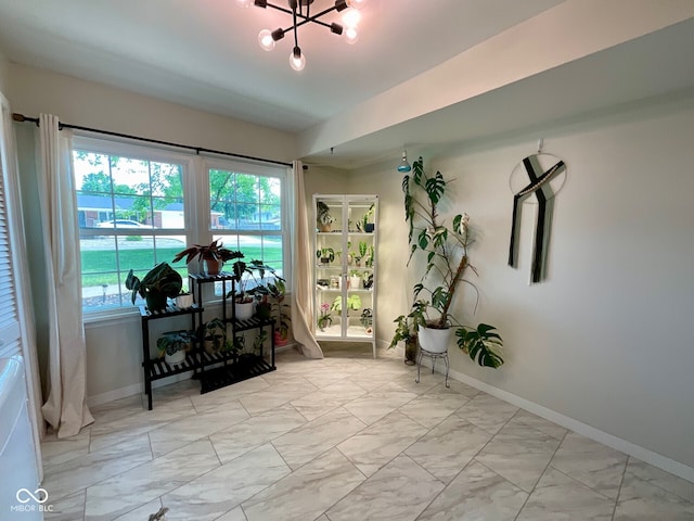 3520 Lantern Ln, Columbus, IN 47203 - doorway with light marble finish floors, baseboards, and a chandelier