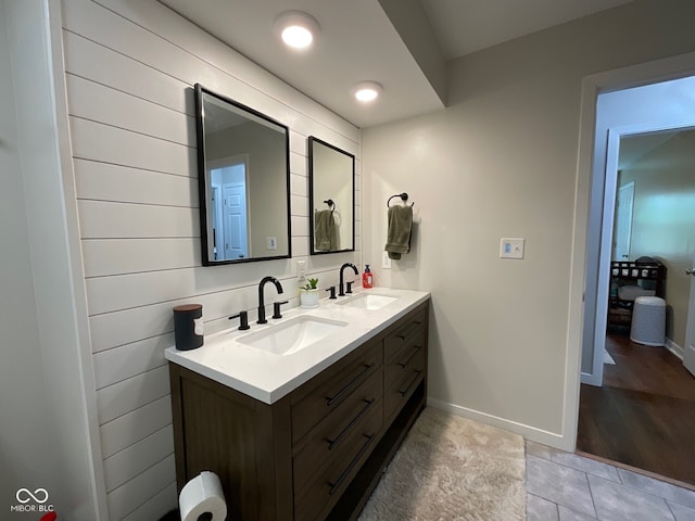 3520 Lantern Ln, Columbus, IN 47203 - bathroom with double vanity, baseboards, and tile patterned floors