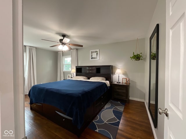 3520 Lantern Ln, Columbus, IN 47203 - bedroom with dark wood-style floors, baseboards, and a ceiling fan