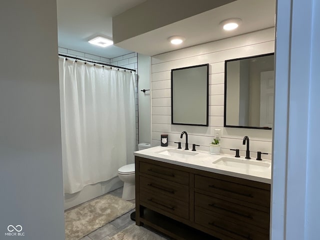 3520 Lantern Ln, Columbus, IN 47203 - bathroom with toilet, double vanity, shower / bath combo with shower curtain, and tile patterned flooring