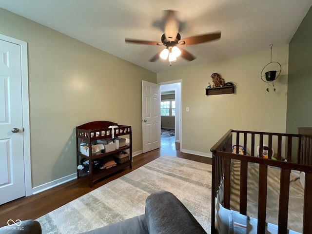 3520 Lantern Ln, Columbus, IN 47203 - bedroom featuring baseboards, wood finished floors, and a ceiling fan