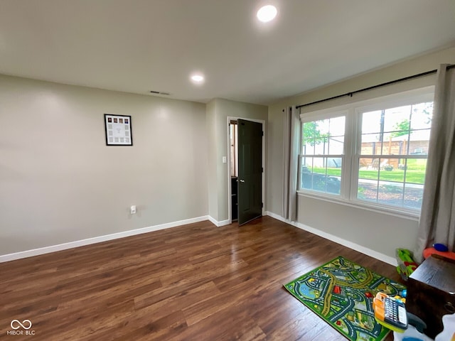 3520 Lantern Ln, Columbus, IN 47203 - playroom with baseboards, dark wood-style floors, and recessed lighting