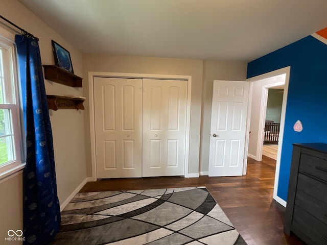 3520 Lantern Ln, Columbus, IN 47203 - unfurnished bedroom with wood finished floors, a closet, and baseboards