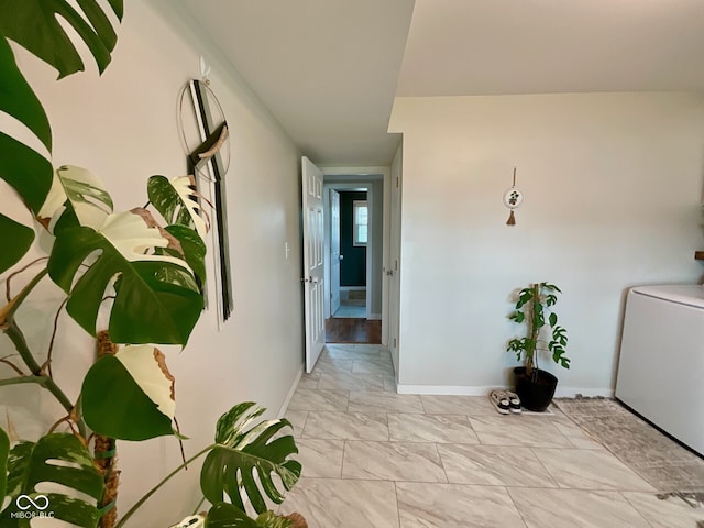 3520 Lantern Ln, Columbus, IN 47203 - corridor with baseboards, light marble finish floors, and washer / dryer
