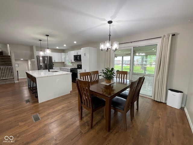 3520 Lantern Ln, Columbus, IN 47203 - dining room with a chandelier, dark wood-type flooring, stairway, recessed lighting, and baseboards