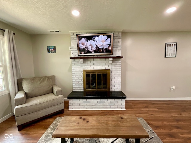 3520 Lantern Ln, Columbus, IN 47203 - living room featuring wood finished floors, baseboards, a brick fireplace, and recessed lighting