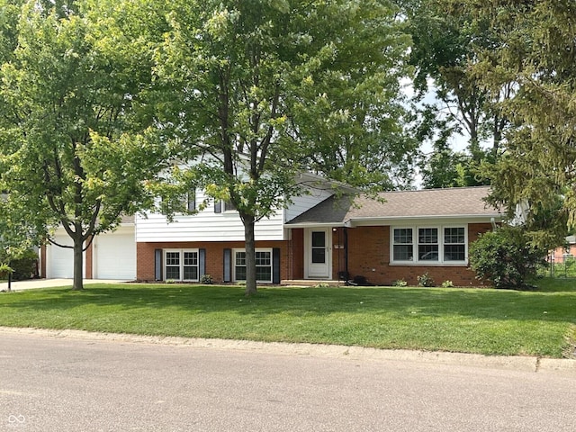 3520 Lantern Ln, Columbus, IN 47203 - split level home featuring brick siding, a front yard, a garage, and driveway
