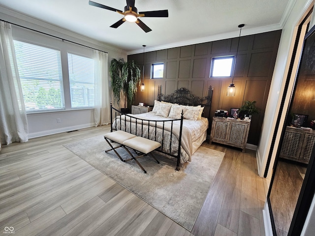 5686 Ellie Ct, Noblesville, IN 46062 - bedroom featuring crown molding, a decorative wall, multiple windows, baseboards, and light wood finished floors