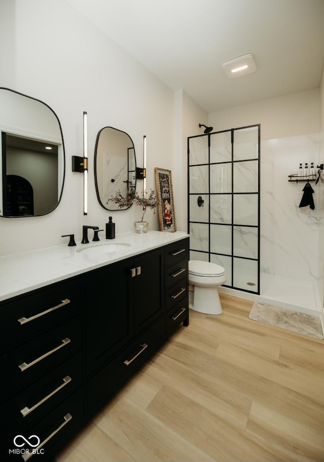 5686 Ellie Ct, Noblesville, IN 46062 - bathroom with wood finished floors, vanity, a marble finish shower, and toilet