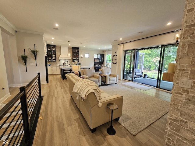 5686 Ellie Ct, Noblesville, IN 46062 - living area with recessed lighting, light wood finished floors, ornamental molding, and baseboards