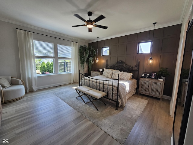 5686 Ellie Ct, Noblesville, IN 46062 - bedroom with ornamental molding, multiple windows, baseboards, light wood finished floors, and a decorative wall