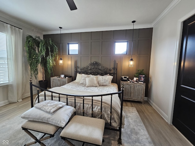 5686 Ellie Ct, Noblesville, IN 46062 - bedroom featuring light wood-style floors, ornamental molding, baseboards, a decorative wall, and ceiling fan