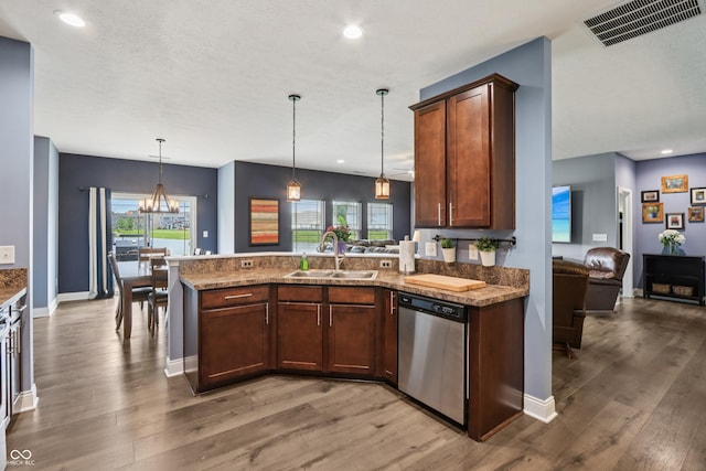 1893 Devonshire Ave, Avon, IN 46123 - kitchen featuring dishwasher, a sink, a peninsula, light wood-type flooring, and decorative light fixtures