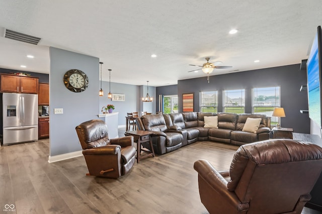 1893 Devonshire Ave, Avon, IN 46123 - living area with a ceiling fan, a chandelier, wood finished floors, recessed lighting, and baseboards