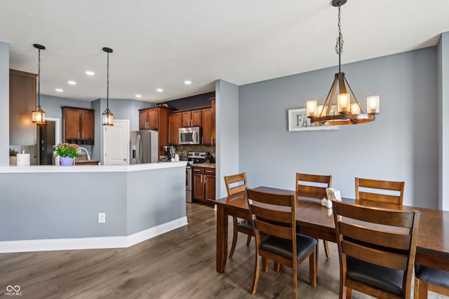 1893 Devonshire Ave, Avon, IN 46123 - dining room with dark wood-style flooring, a chandelier, recessed lighting, and baseboards