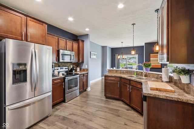 1893 Devonshire Ave, Avon, IN 46123 - kitchen featuring appliances with stainless steel finishes, a sink, light wood-type flooring, decorative backsplash, and recessed lighting